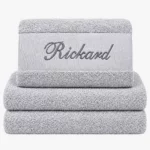 Gray towel with name and black text
